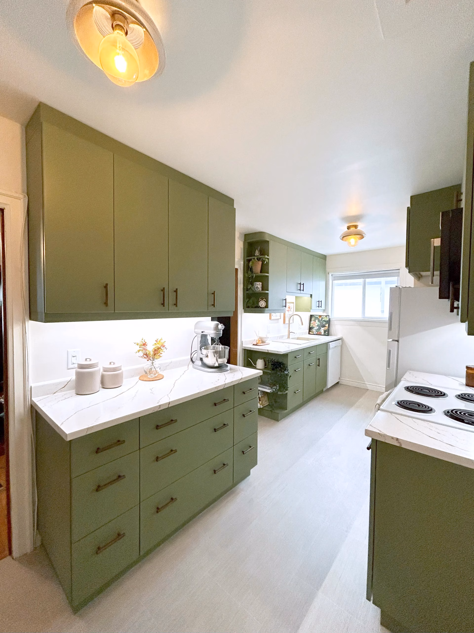 Kitchen with green cabinetry, alternate view