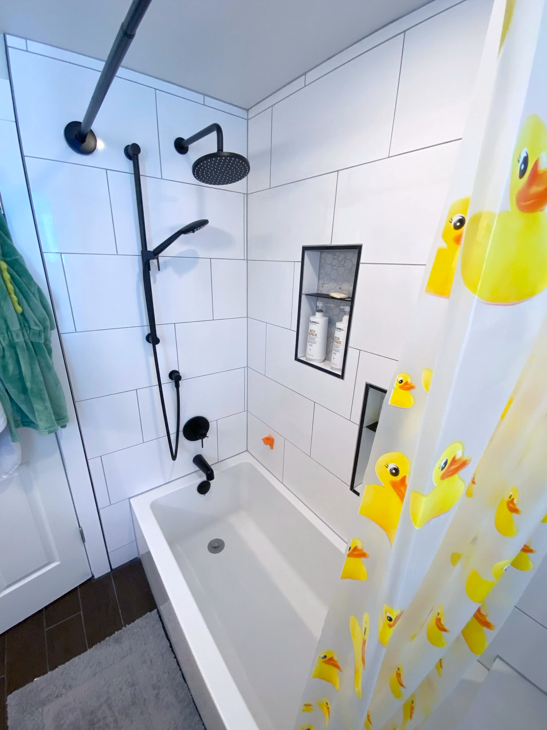 Walk-in shower with a duck-themed curtain