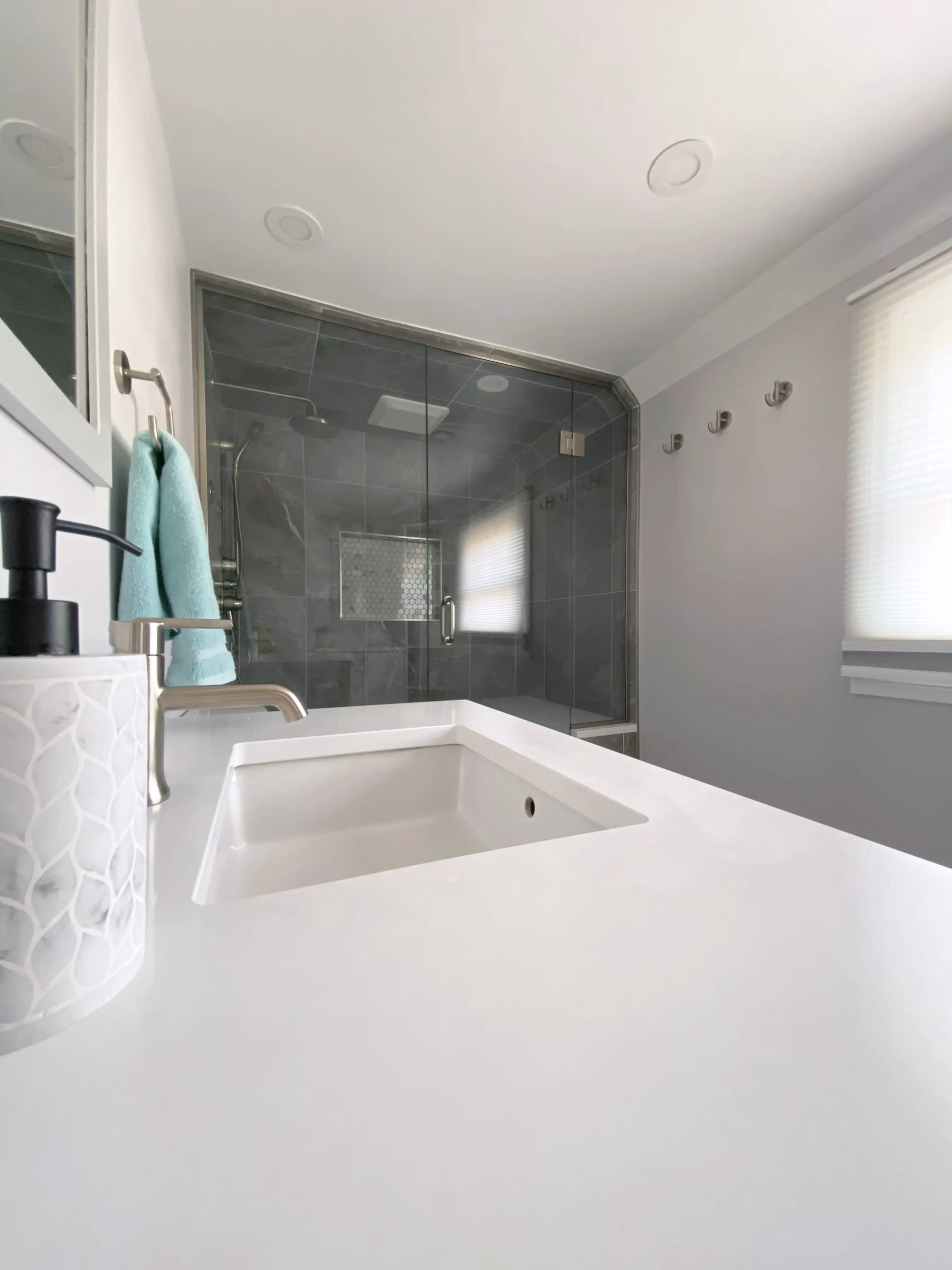 Tiled shower and vanity, angled view