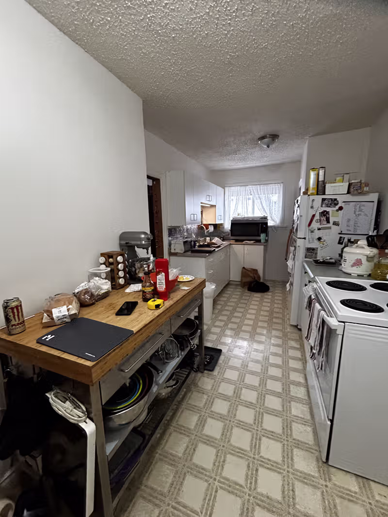 Ferry Road Kitchen before renovations: dated flooring, minimal cabinetry and lots of clutter due to lack of storage.