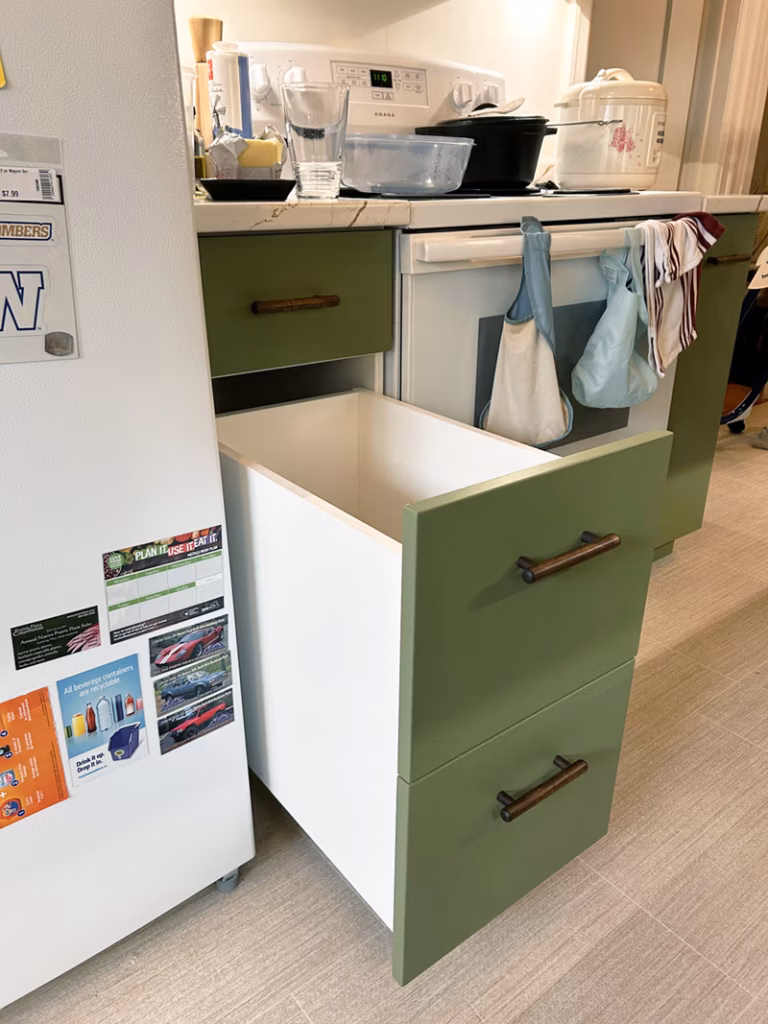 Picture of a custom drawer with green drawer fronts designed to hold large amounts of rice.