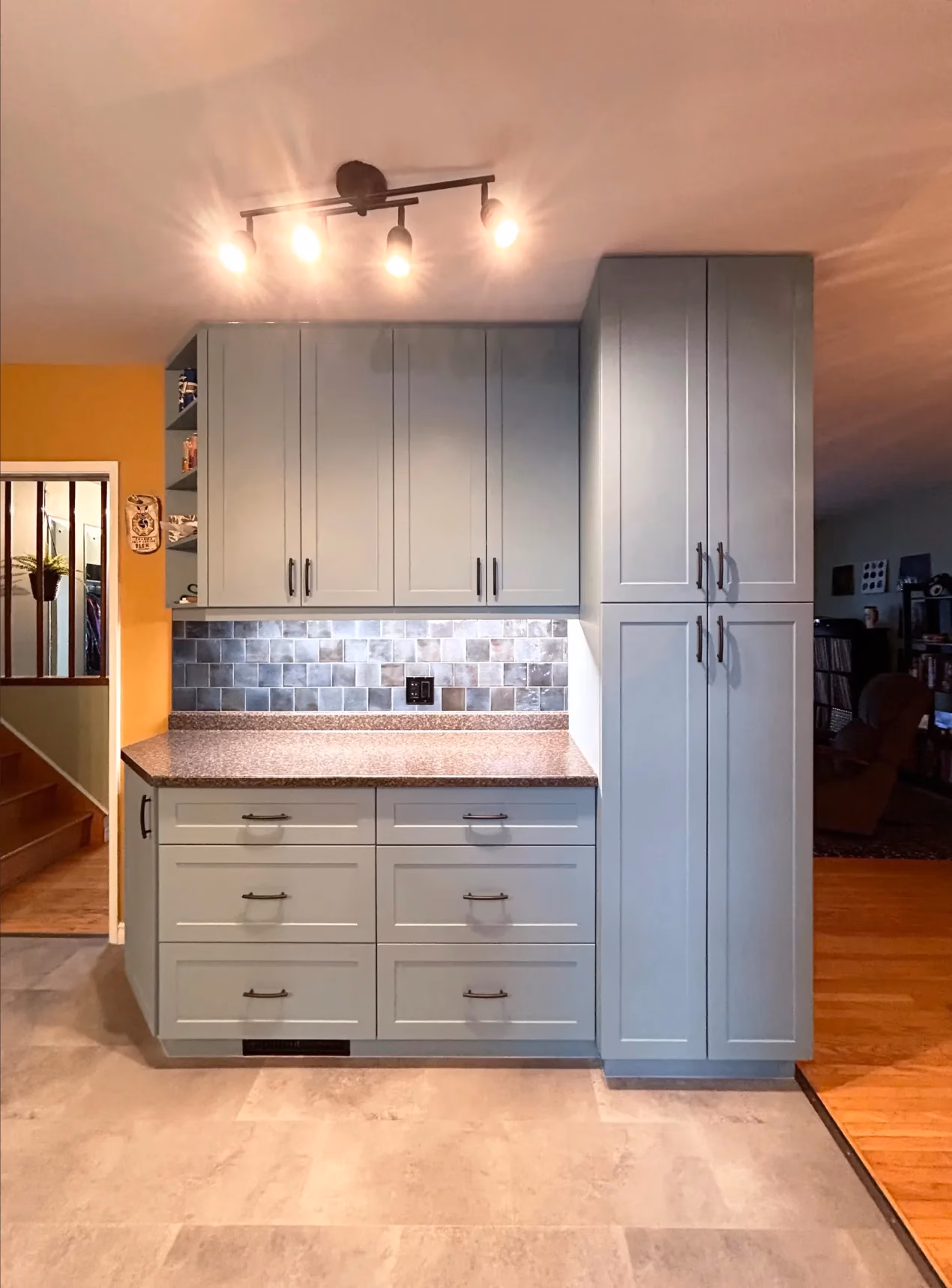 Blue-gray kitchen pantry cabinetry after renovation